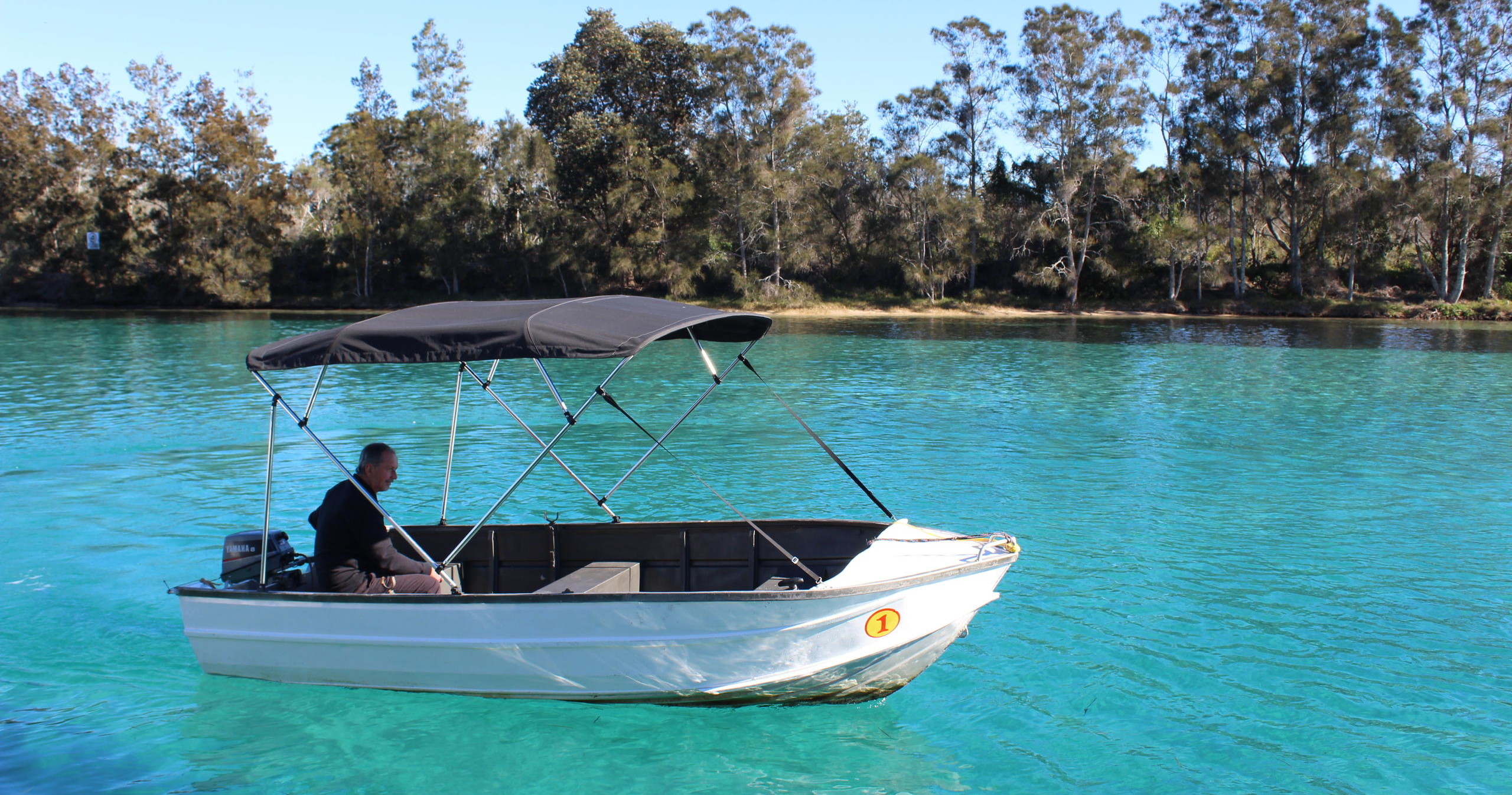 Half cabin runabout boat hire on Wallis Lake Forster NSW — enclosed cabin for wind and rain protection on the lake